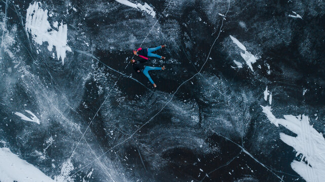 aerial view of a lovely couple in the middle of a frozen river