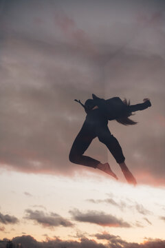 double exposure of a dancing girl in the clouds