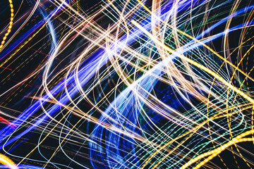 Neon lights background. Motion lines texture. Long exposure moving light pattern. Abstract night life background. Glowing lines design. Colorful illumination. Chaos texture.