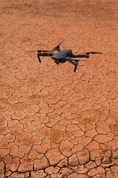 Black drone flying in arid desert
