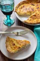 home made quiche Lorraine with a glass of red wine 