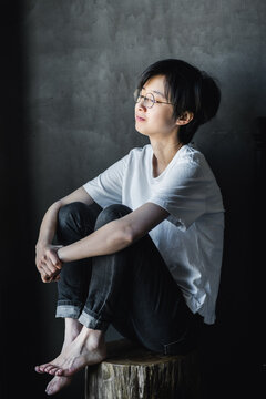 woman sitting on a wooden stool