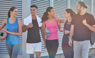 Fototapeta premium Young fitness team talking while going to workout gym