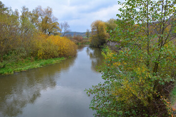 Fototapeta na wymiar Autumn landscape with a small river