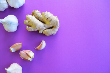 Creative mockup of garlic and ginger on a colored background. Flat lay. Food concept.