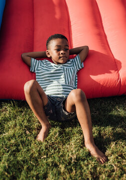 Young boy jumping outdoors in jump house
