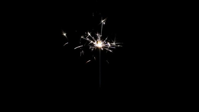 Lightening Christmas sparkler on the black background. Christmas sparkler concept. Bengal lights are burning on a black background. Holiday party concept. Christmas and newyear party sparkler.