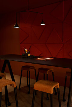 Table and chairs near geometric wall