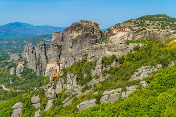 Amazing panoramic view of the monasteries (Varlaam, Rousanou, St. Nicolaus, an Great Meteoron) of Meteora, Thessaly, Greece with spectacular unique rock formations