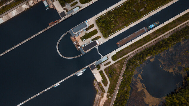 Top-view of a barge ship passing by the gateway