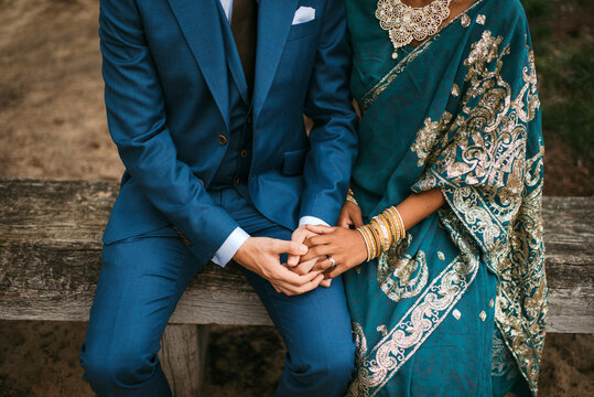 Indian bride holding hands with her husband