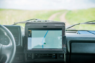 gps application in the car with tablet screen computer Sun light  inside brutal SUV car