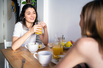 Two Young Girls Talking At Home.