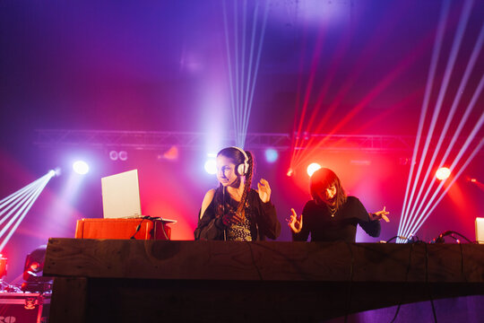 Young DJ women playing music at a party