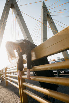 Young blonde woman on a bridge