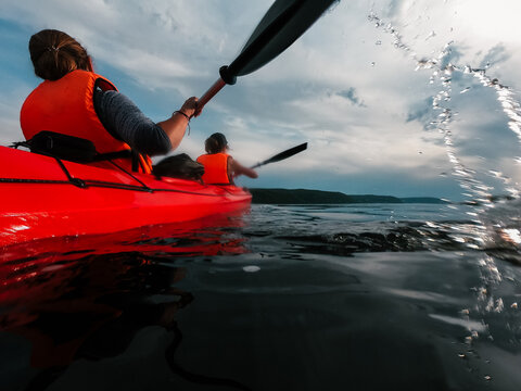 Two sisters go kayaking on a sunny summer day