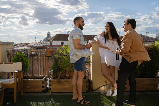 3 Friends Talking In A Terrace At Sunset.