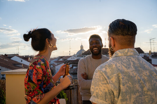 Friends Having Fun In A Terrace At Sunset.
