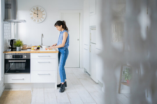 Young Woman In The Kitchen.