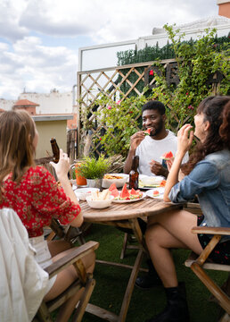 Multiracial Friends Having Fun In A Terrace.