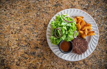 Hamburger Patty with green salad and steak fries