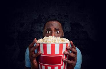 Worried boy watches a horror film. concept of entertainment and streaming tv.