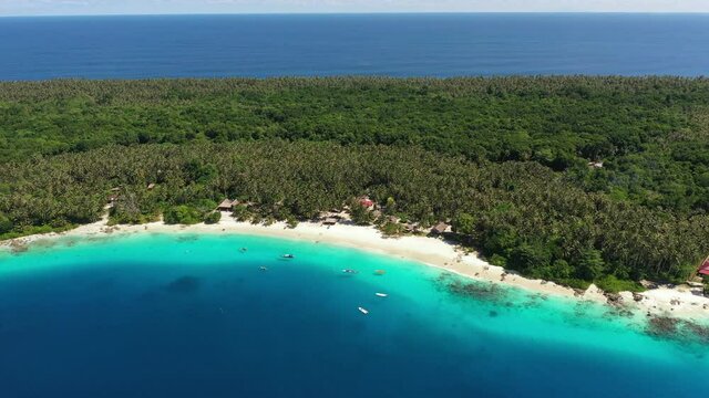Drone flying slowly away from paradise island Asu Island, North Sumatra, Indonesia
