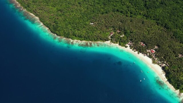 Aerial view of blue water surrounding Asu Island, North Sumatra, Indonesia and beach on the island