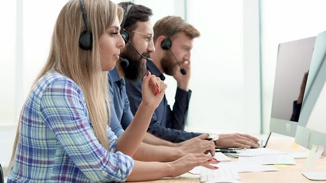 call center operators in the headset advising clients online .