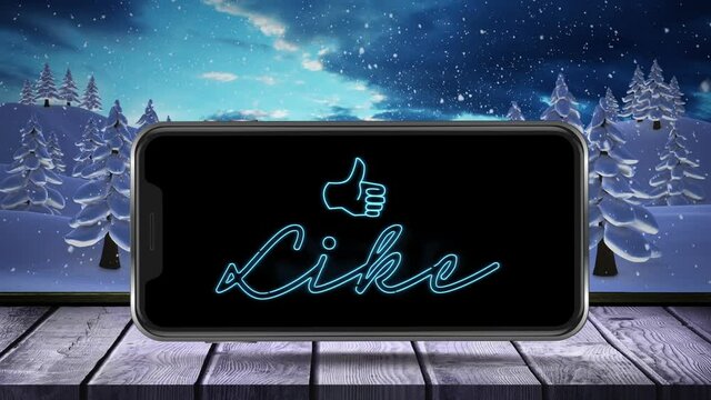 Animation of flickering like text and thumbs up displayed on smartphone screen on wooden surface wit