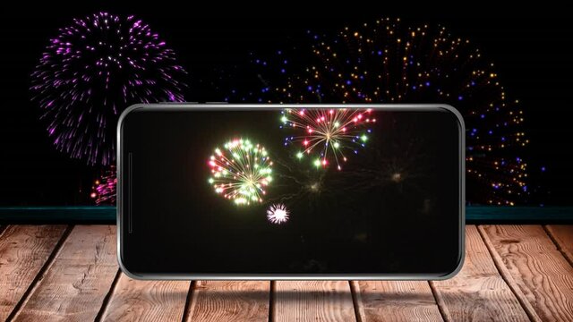 Animation of fireworks exploding displayed on smartphone screen and on black background