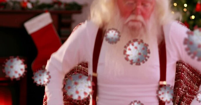 Animation of covid 19 cells moving over sleeping santa claus in armchair in the background