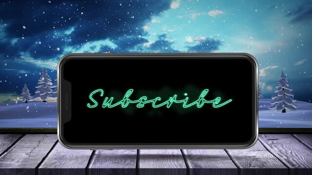 Digital animation of subscribe neon text on smartphone screen over wooden surface