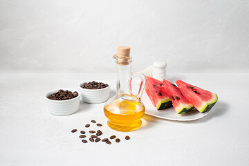 Watermelon seed oil in the bottle on white background. Horizontal composition.