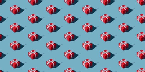 Christmas isometric pattern, background, banner. Minimal composition made of Christmas red gift box on a blue background. Top view. Holiday New Year concept. Xmas presents, congratulations