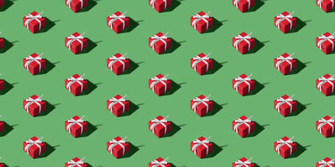 Christmas isometric pattern, background, banner. Minimal composition made of Christmas red gift box on a green background. Top view. Holiday New Year concept. Xmas presents, congratulations