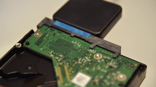 Close up of connecting a chip via an adapter to an external device. Media. Male hand connecting an adapter to a microcircuit, concept of neuronet and computer technologies.