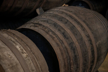 Obraz premium Old porto lodge with rows of oak wooden casks for slow aging of fortified ruby or tawny porto wine in Vila Nova de Gaia, Portugal