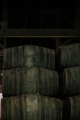 Old porto lodge with rows of oak wooden casks for slow aging of fortified ruby or tawny porto wine in Vila Nova de Gaia, Portugal