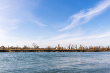 Landscape of river, coast and blue sky.