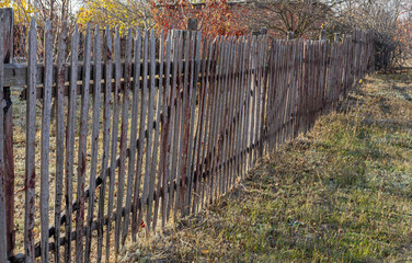 Long old wooden fence in the village 
