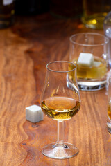 Tasting glass with strong alcoholic spirit drink whisky, cognac, armagnac or calvados