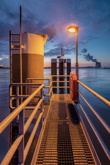 Obraz premium Illuminated boat dock with steel mooring posts in Port of Antwerp.