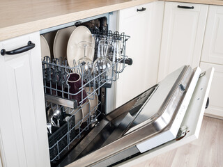 dishwasher close-up with washed dishes, easy to use and save water, eco-friendly, built-in kitchen dish washing machine