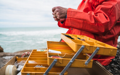 Fisherman with fishing equipment box.