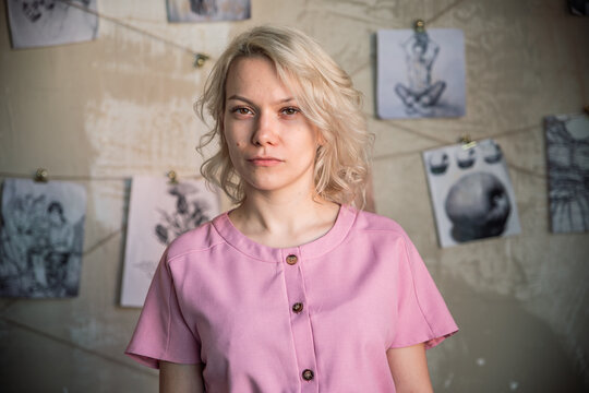 Girl in pink dress against the background of drawings