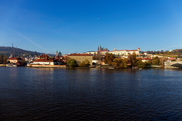 Fototapeta na wymiar Autumn colorful Prague Lesser Town with gothic Castle above River Vltava in the sunny Day, Czech Republic