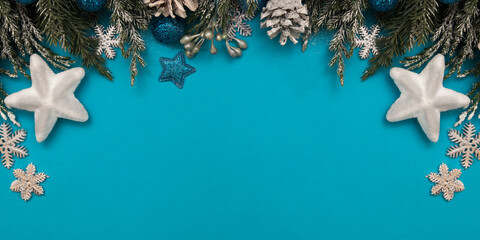 Winter holiday decoration card festive concept: Christmas trees, stars and balls on blue background with copy space