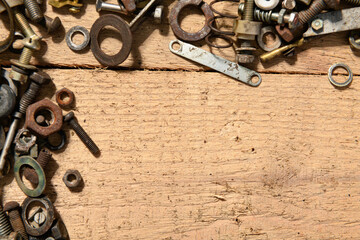 frame with blank space or place for text from old vintage hand tools, screws and nuts on a wooden background