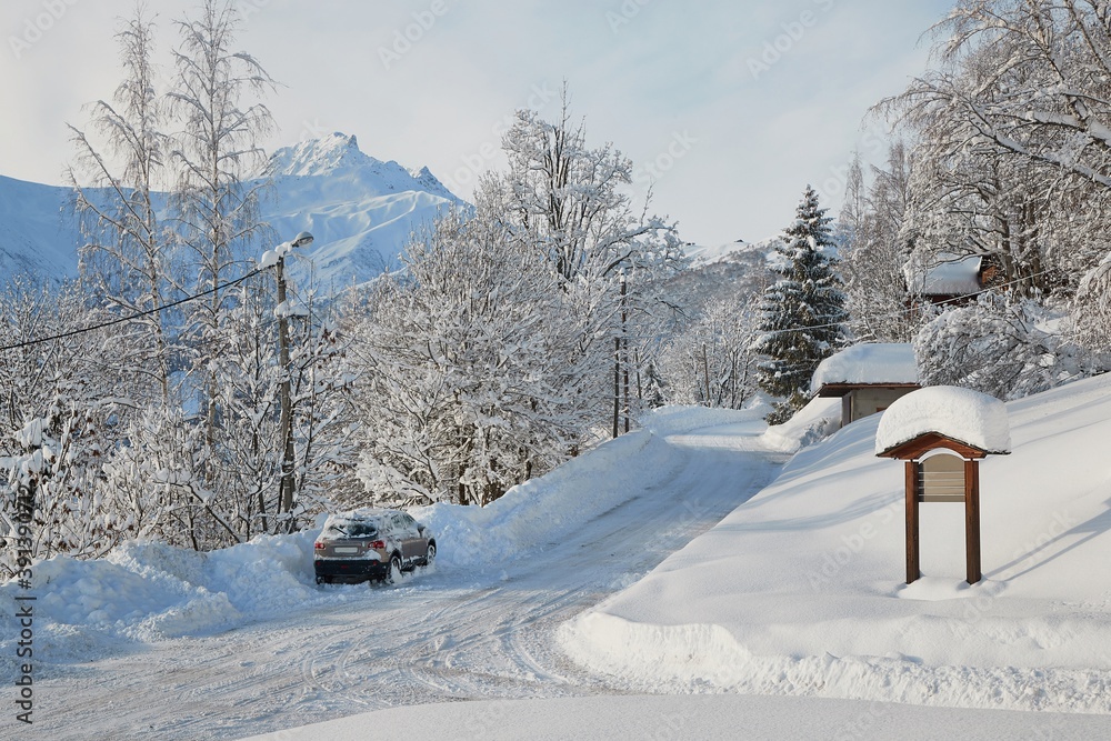 Wall mural mountain road in winter snowy village